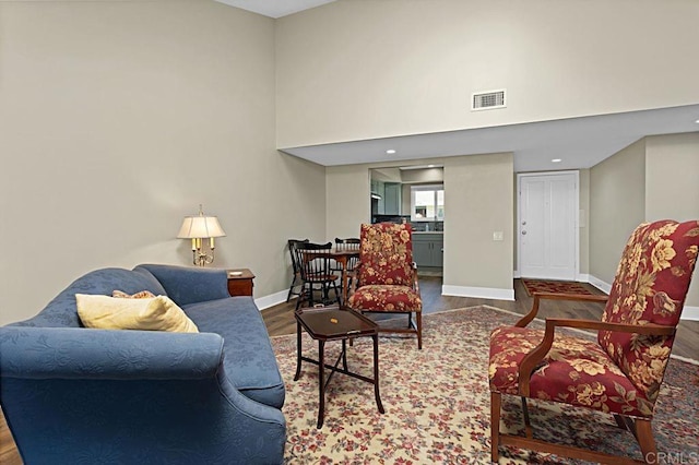 3685 Vista Campana N Unit 72, Oceanside, CA 92057 - living area featuring wood finished floors, baseboards, and a high ceiling