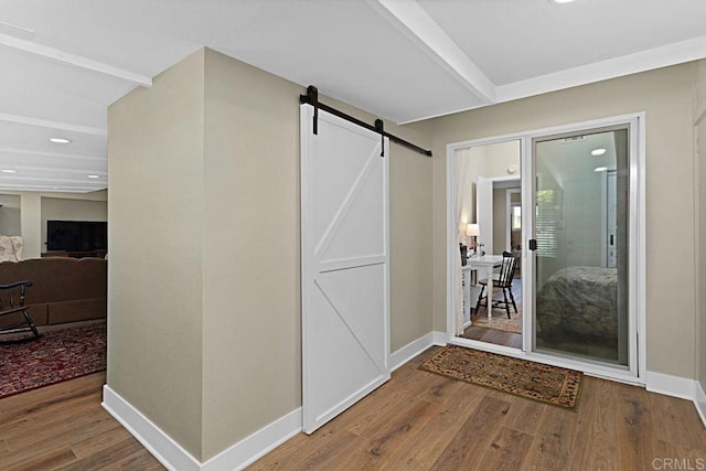 3685 Vista Campana N Unit 72, Oceanside, CA 92057 - corridor with a barn door, wood finished floors, baseboards, and recessed lighting