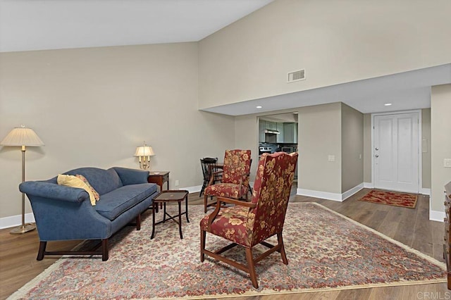 3685 Vista Campana N Unit 72, Oceanside, CA 92057 - living room featuring wood finished floors, baseboards, and high vaulted ceiling
