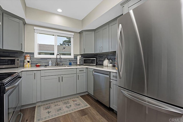 3685 Vista Campana N Unit 72, Oceanside, CA 92057 - kitchen featuring appliances with stainless steel finishes, gray cabinetry, a sink, tasteful backsplash, and light countertops