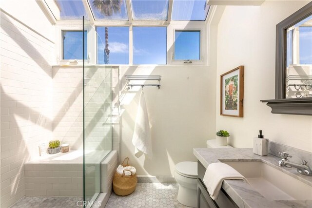 16865 S Pacific Ave, Sunset Beach, CA 90742 - bathroom featuring vanity, toilet, a stall shower, and tile patterned floors