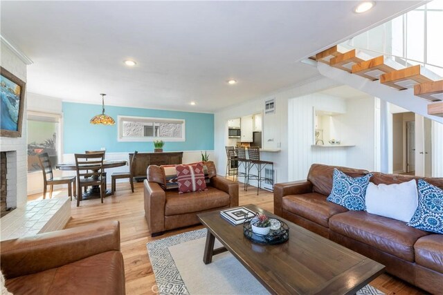 16865 S Pacific Ave, Sunset Beach, CA 90742 - living area featuring light wood finished floors, healthy amount of natural light, recessed lighting, and a fireplace