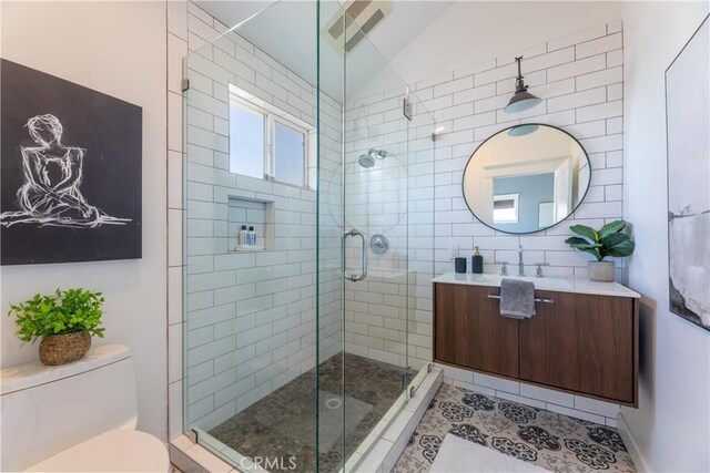 16865 S Pacific Ave, Sunset Beach, CA 90742 - full bath with vanity, a shower stall, toilet, tile patterned floors, and lofted ceiling