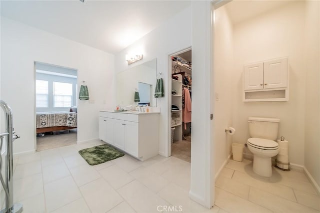 14168 Georgetown St, Hesperia, CA 92344 - full bath with vanity, ensuite bath, a walk in closet, toilet, and baseboards
