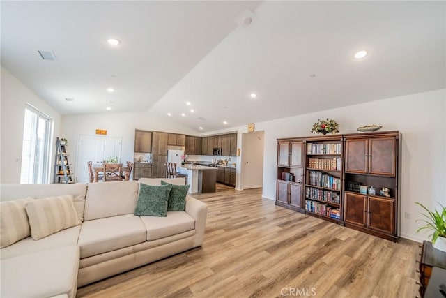 14168 Georgetown St, Hesperia, CA 92344 - living room featuring lofted ceiling, light wood-type flooring, and recessed lighting