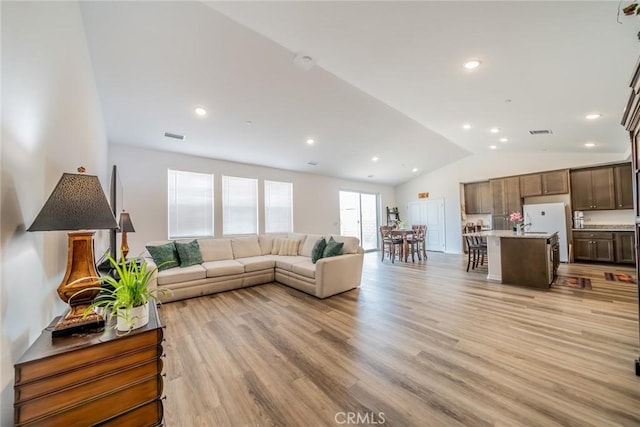 14168 Georgetown St, Hesperia, CA 92344 - living area with vaulted ceiling, light wood-style flooring, and recessed lighting