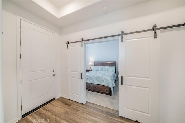 14168 Georgetown St, Hesperia, CA 92344 - bedroom with a barn door and wood finished floors