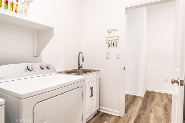 14168 Georgetown St, Hesperia, CA 92344 - washroom with washer / clothes dryer, cabinet space, light wood-style flooring, and baseboards