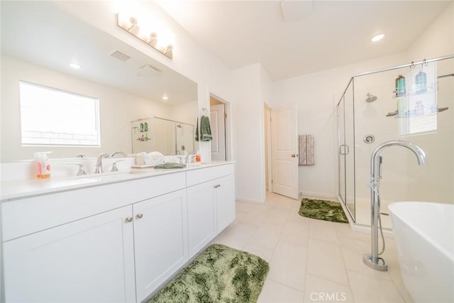 14168 Georgetown St, Hesperia, CA 92344 - bathroom with double vanity, a stall shower, a freestanding tub, tile patterned floors, and recessed lighting