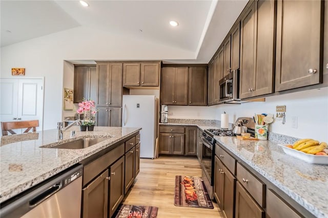 14168 Georgetown St, Hesperia, CA 92344 - kitchen with stainless steel appliances, a sink, vaulted ceiling, light stone counters, and light wood finished floors