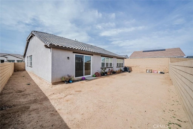 14168 Georgetown St, Hesperia, CA 92344 - back of property with a fenced backyard, stucco siding, and a tiled roof