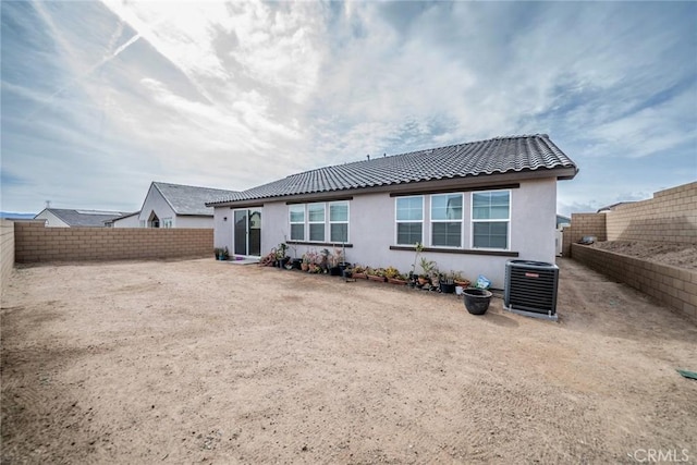 14168 Georgetown St, Hesperia, CA 92344 - rear view of house featuring central air condition unit, stucco siding, a tiled roof, and a fenced backyard