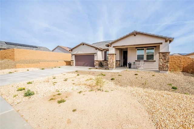 14168 Georgetown St, Hesperia, CA 92344 - ranch-style house with stucco siding, stone siding, concrete driveway, covered porch, and a garage