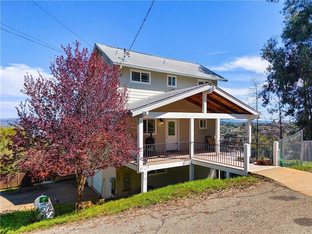 rear view of property featuring fence