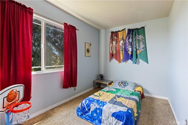 bedroom with carpet flooring and baseboards