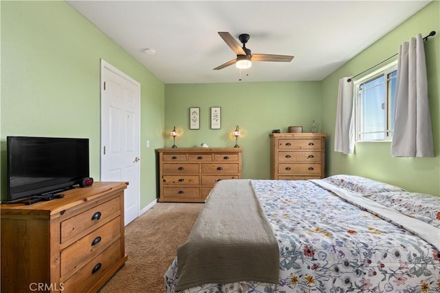 carpeted bedroom featuring baseboards and a ceiling fan