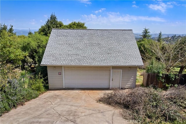 detached garage featuring fence