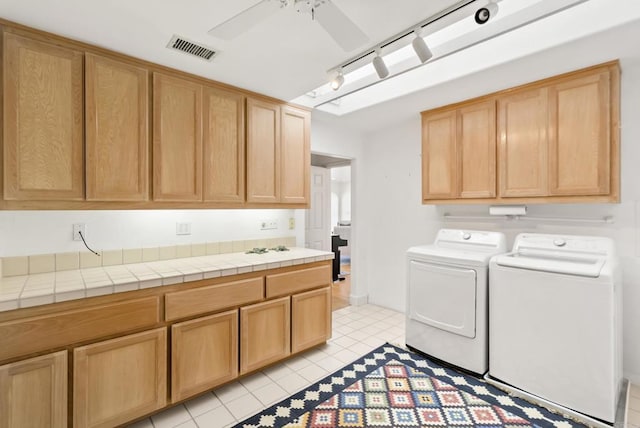 1552 Camino Del Mar Unit 623/625, Del Mar, CA 92014 - laundry room with washer and clothes dryer, cabinet space, and light tile patterned flooring