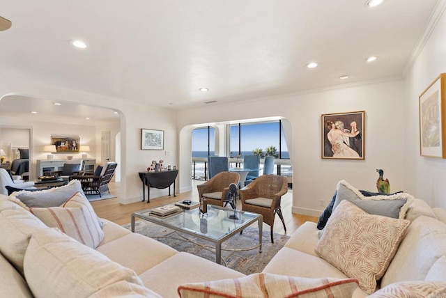 1552 Camino Del Mar Unit 623/625, Del Mar, CA 92014 - living room featuring arched walkways, light wood-style flooring, crown molding, recessed lighting, and baseboards