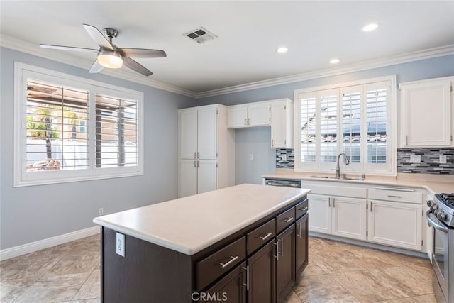 27077 Calendula St, Corona, CA 92883 - kitchen with light countertops, a sink, white cabinetry, and visible vents