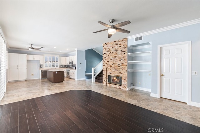 27077 Calendula St, Corona, CA 92883 - unfurnished living room with crown molding, visible vents, a ceiling fan, and light wood-style floors