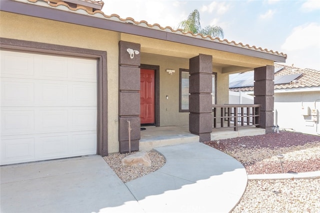 27077 Calendula St, Corona, CA 92883 - doorway to property featuring a porch, a garage, stucco siding, and concrete driveway