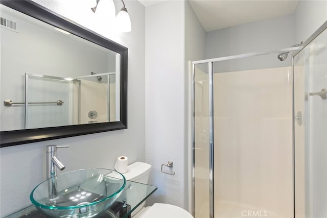 27077 Calendula St, Corona, CA 92883 - bathroom featuring a sink, visible vents, toilet, and a shower stall