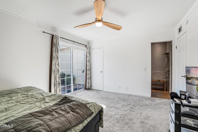 bedroom featuring carpet flooring, ornamental molding, visible vents, and access to exterior