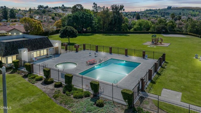 community pool featuring fence, a patio area, and a yard