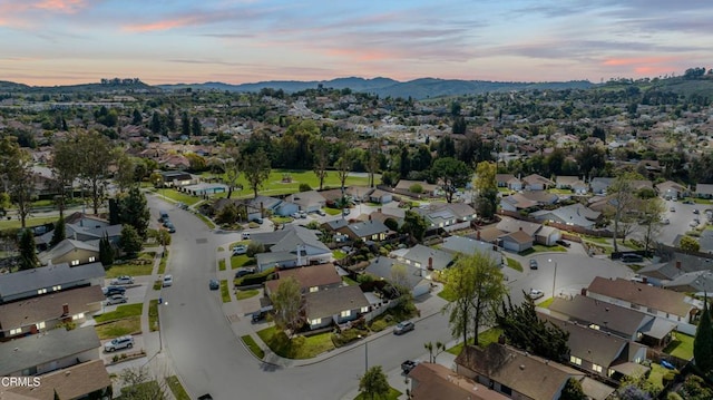 aerial view at dusk with a residential view and a mountain view
