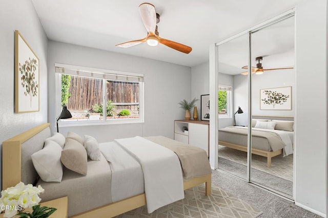 carpeted bedroom featuring a closet and ceiling fan