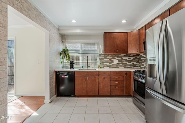 kitchen featuring light countertops, a sink, light tile patterned floors, stainless steel appliances, and ornamental molding