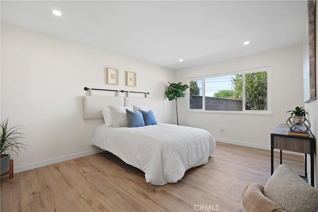 bedroom featuring recessed lighting, wood finished floors, and baseboards