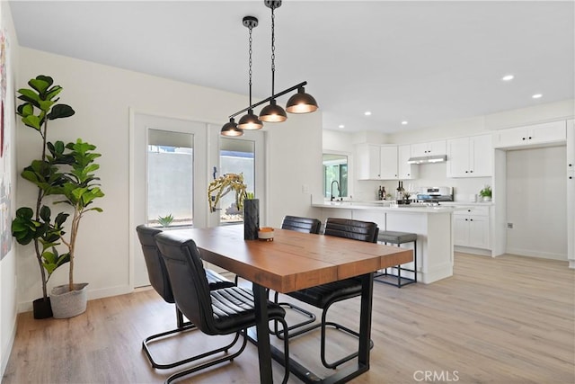 dining area with light wood-type flooring, baseboards, and recessed lighting