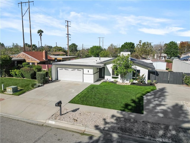 view of front of home featuring a garage, driveway, a front yard, and fence