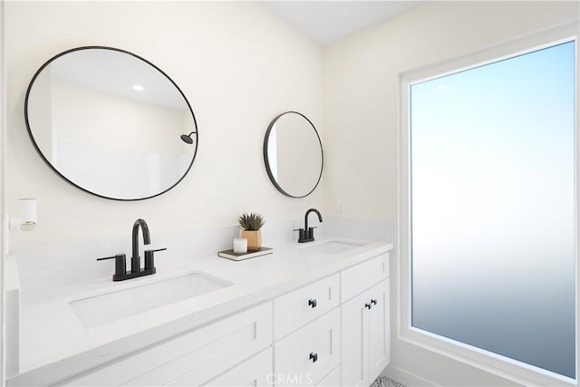 full bath with double vanity and a sink