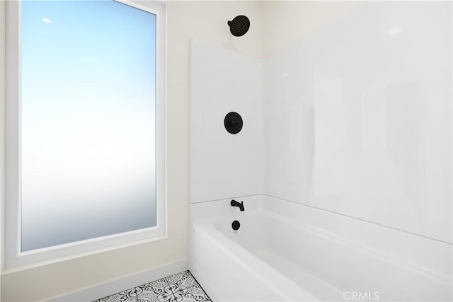 full bath featuring baseboards, tile patterned flooring, and shower / tub combination