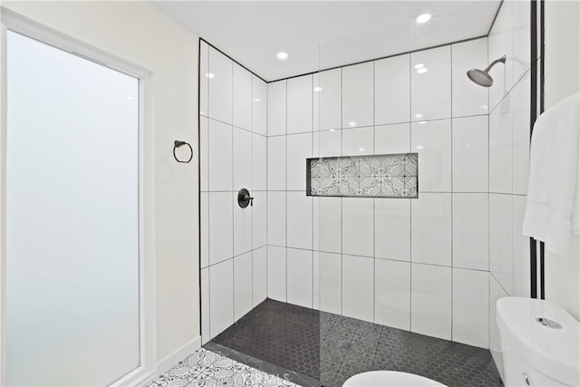 full bathroom featuring recessed lighting, a tile shower, toilet, and tile patterned floors