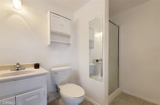 bathroom with vanity, toilet, and a stall shower
