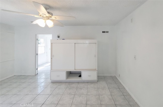 1020 E Rowland Ave, West Covina, CA 91790 - empty room with light tile patterned flooring, a textured ceiling, and a ceiling fan