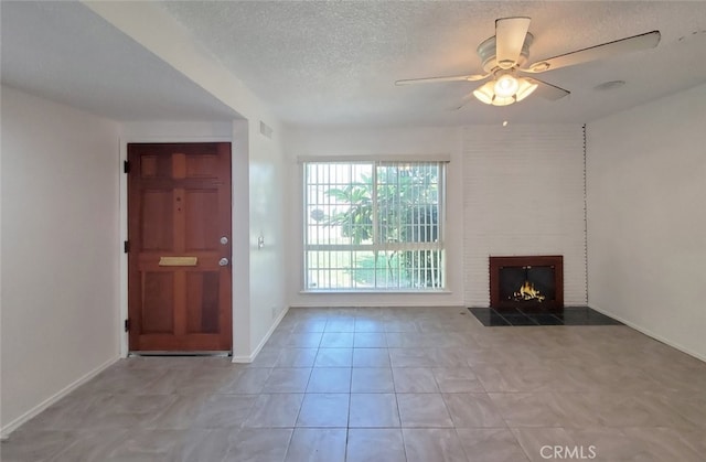 1020 E Rowland Ave, West Covina, CA 91790 - unfurnished living room with ceiling fan, a textured ceiling, a fireplace, and tile patterned flooring