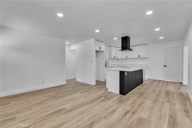 26339 First St, Loma Linda, CA 92318 - kitchen with wall chimney exhaust hood, a sink, white cabinetry, baseboards, and recessed lighting