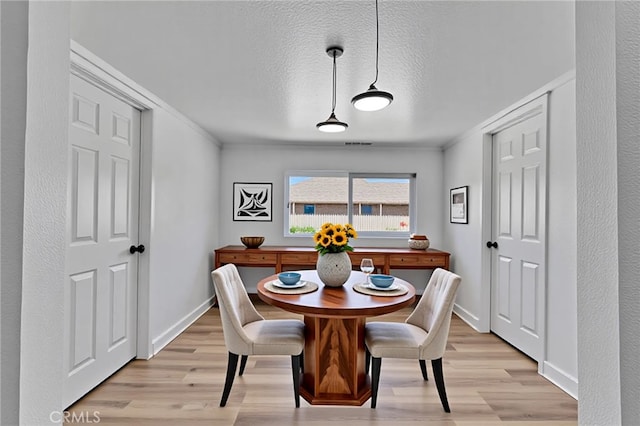 26339 First St, Loma Linda, CA 92318 - dining space featuring light wood-style floors, ornamental molding, baseboards, and a textured ceiling