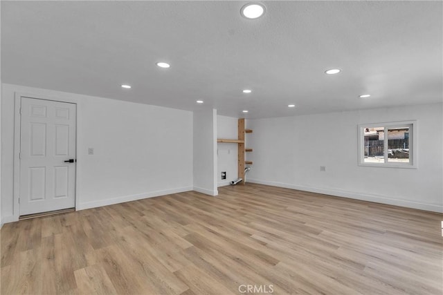interior space with light wood-type flooring, baseboards, and recessed lighting