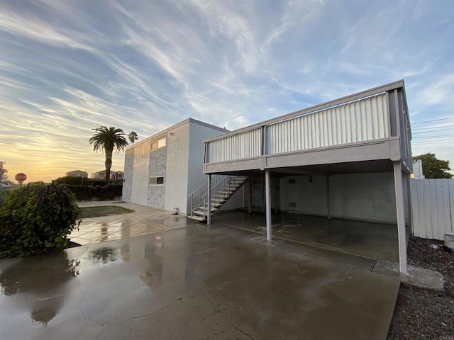 exterior space featuring a patio area, fence, and stairs