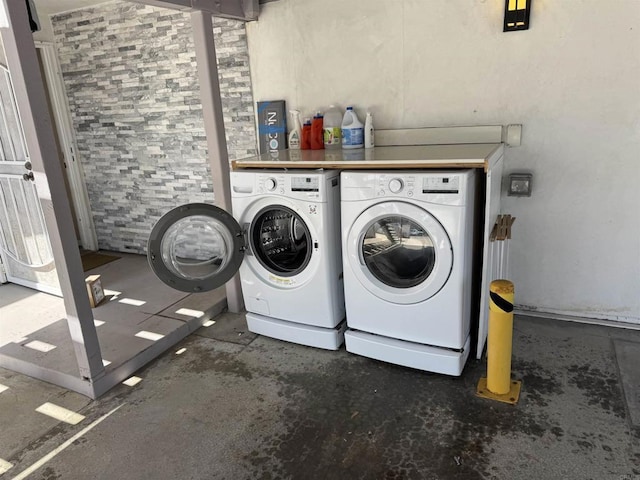 clothes washing area with independent washer and dryer and laundry area