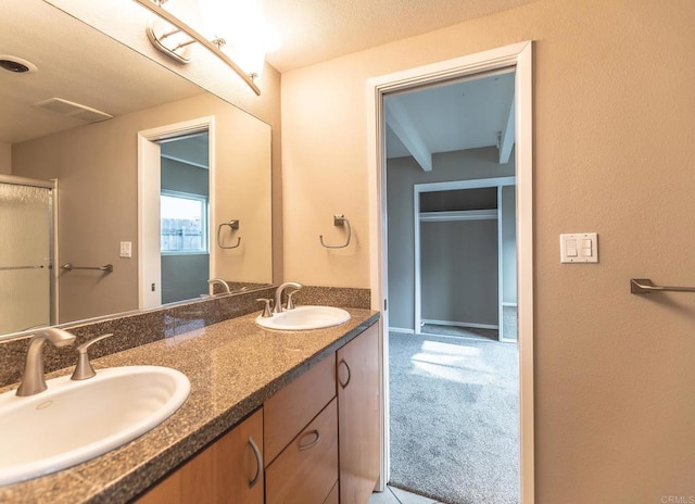 bathroom featuring double vanity, a sink, and visible vents