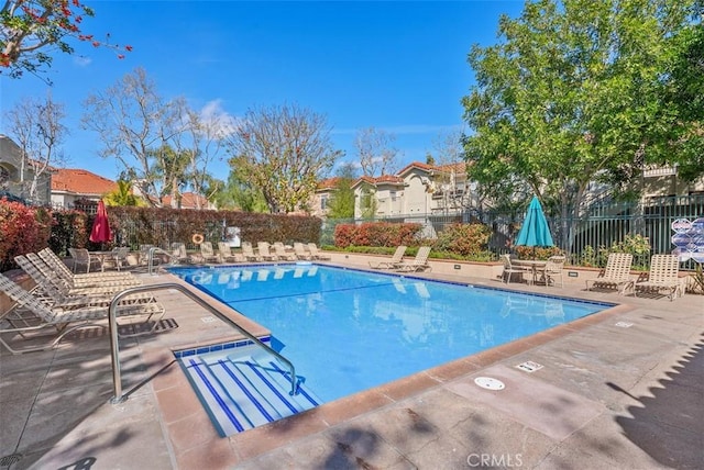 pool featuring a patio area and fence