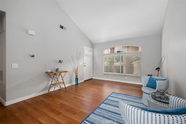183 Cinnamon Teal, Aliso Viejo, CA 92656 - living area featuring wood finished floors, baseboards, and high vaulted ceiling