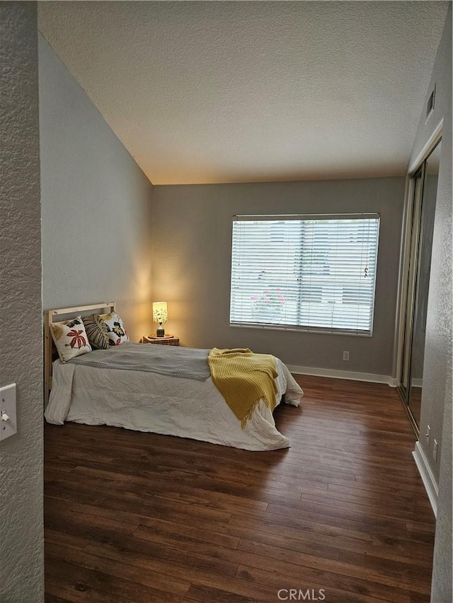 183 Cinnamon Teal, Aliso Viejo, CA 92656 - bedroom with wood finished floors, a textured ceiling, baseboards, and a textured wall